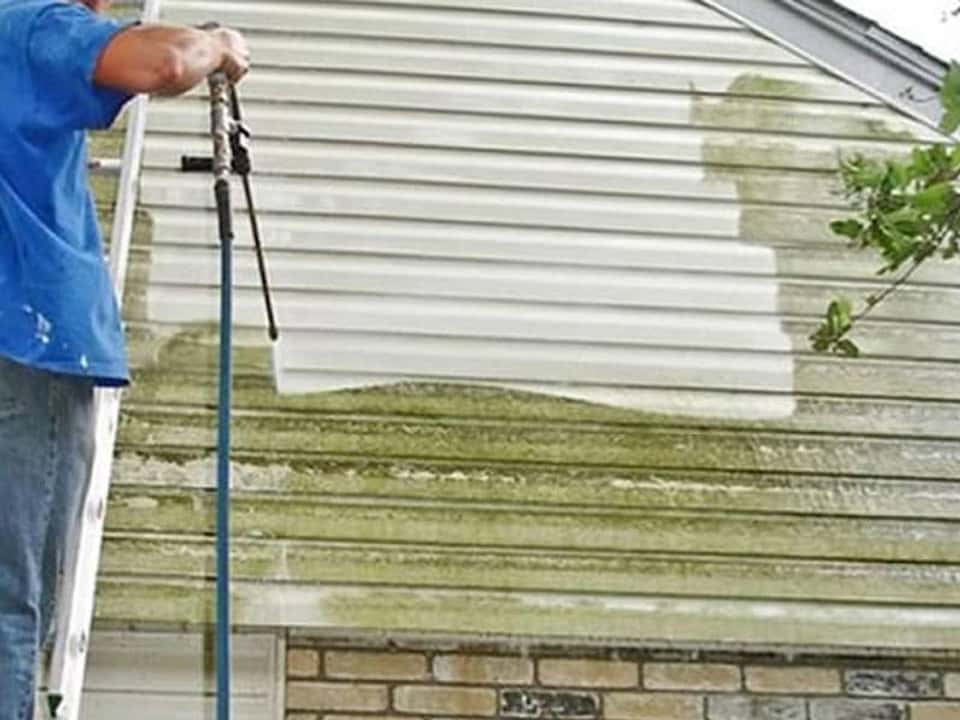 Picture of house siding before and after professional pressure washing